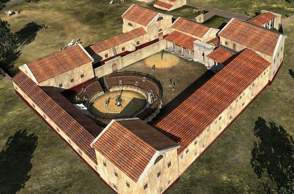 Reconstitution d'une école de gladiateurs sur le site de Carnuntum. De grands bâtiments à étages sont dotés d'une arène d'entraînement dans une cour rectangulaire centrale entourée de portiques - LBI ArchPro | Creative Commons BY-SA 2.5